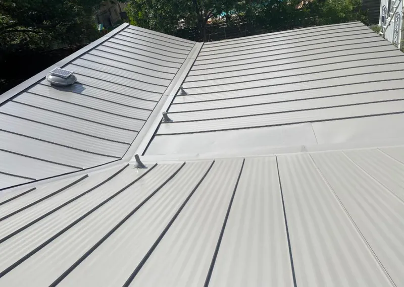 Solar attic fan installed on a metal roof for Roof Ventilation in Grandwood Park